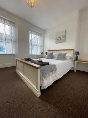 a bedroom with a large bed and a window at Triple Deck Cottage - 2mins from Mevagissey Harbour in Mevagissey