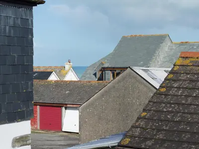 a view of roofs of houses with a red door at Sea Glimpses in Port Isaac