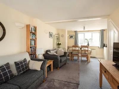 a living room with a couch and chairs and a table at Sea Glimpses in Port Isaac