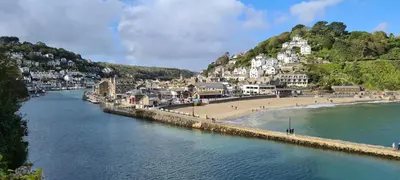 a view of a beach next to a body of water at Cosy Bake Cottage, Great Location in Looe, Cornwall in Looe