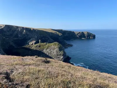a view of the ocean from a rocky cliff at Sunny Corner, Padstow. Spacious 3 bedrooms, 2.5 bathrooms, parking, garden. in Padstow