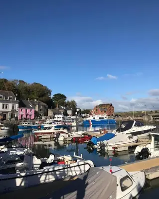a bunch of boats are docked in a harbor at Sunny Corner, Padstow. Spacious 3 bedrooms, 2.5 bathrooms, parking, garden. in Padstow