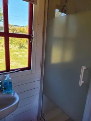 a bathroom with a sink and a window at Glamping Pod in St Austell Sleeps 2 with Spa Pool in St Austell