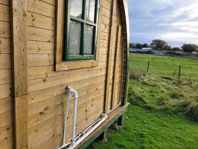a building with a window on the side of it at Cozy Cabin Retreat in Saint Austell in Lanivet