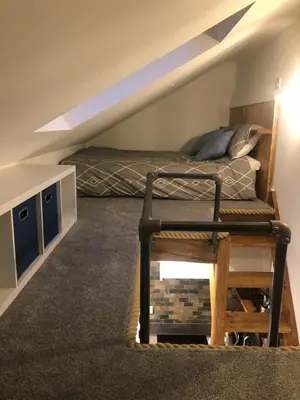 a bedroom with a bed and a chair in a attic at Piala retreat in Phillack