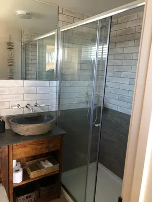 a bathroom with a sink and a glass shower at Piala retreat in Phillack