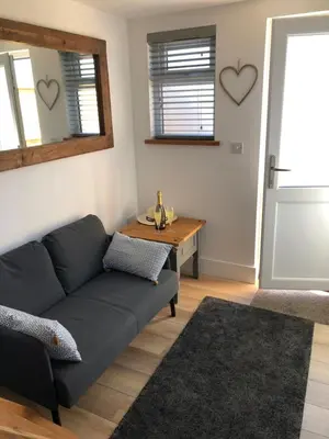 a living room with a couch and a table at Piala retreat in Phillack