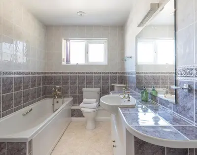 a bathroom with a tub and a toilet and a sink at Beaches in Polzeath