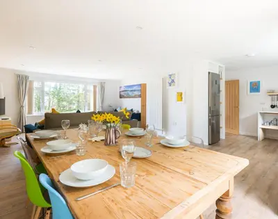 a large wooden table in a living room at Beaches in Polzeath