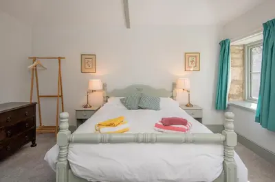 a bedroom with a bed with towels on it at Doolans in Falmouth
