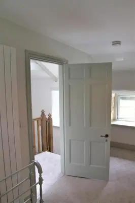 an empty room with a door and a window at Doolans in Falmouth