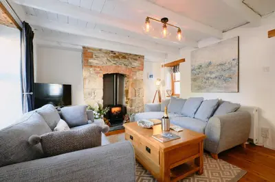 a living room with two couches and a fireplace at Finest Retreats - Scallop Cottage in Porthleven