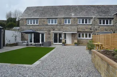 a house with a lawn in front of it at The Cottage, Treliggon Farm in Lanivet