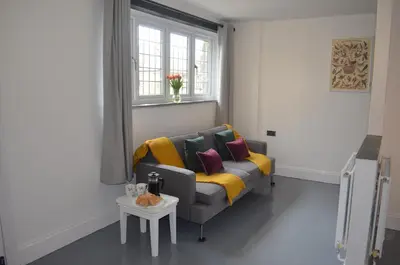 a living room with a couch and a table at The Cottage, Treliggon Farm in Lanivet