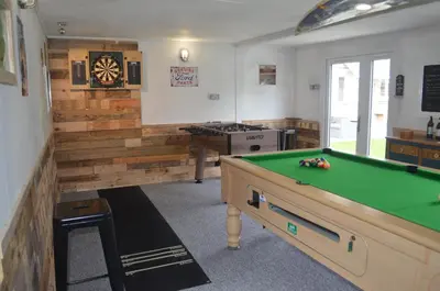 a billiard room with a pool table and a kitchen at The Cottage, Treliggon Farm in Lanivet