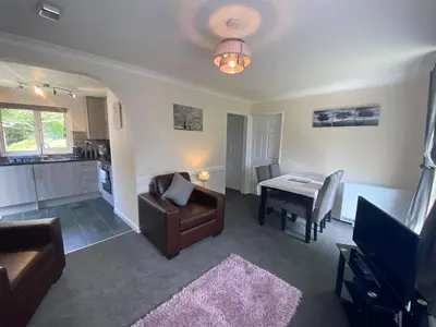 a living room with a couch and a table at Lands End in Liskeard