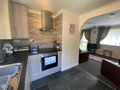 a kitchen with a sink and a stove top oven at Lands End in Liskeard