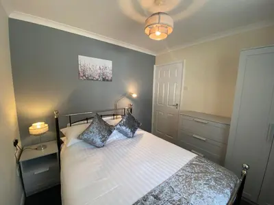 a bedroom with a bed with two pillows on it at Lands End in Liskeard
