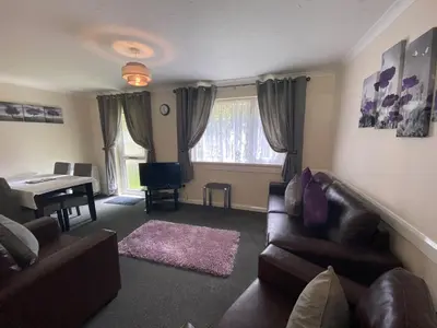 a living room with a couch and a table at Lands End in Liskeard
