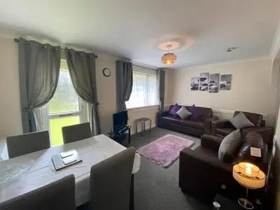 a living room with a table and a couch at Lands End in Liskeard
