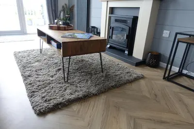 a living room with a coffee table and a fireplace at Padstow Lodge - Padstow Holiday Village in Padstow
