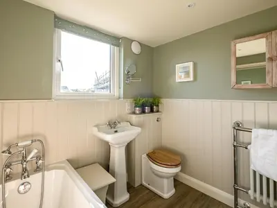 a bathroom with a sink and a toilet and a tub at Atlantis in Polzeath