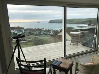 a view of the ocean from a balcony with a camera at Atlantis in Polzeath