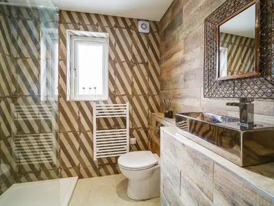 a bathroom with a toilet and a sink and a mirror at Seahaven in Port Isaac