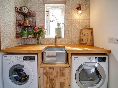 a laundry room with a washer and a sink at Seahaven in Port Isaac