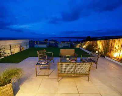 a patio with chairs and a table on a balcony at Seahaven in Port Isaac