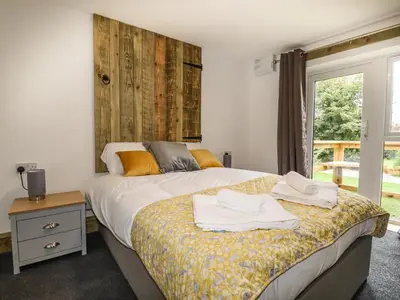 a bedroom with a bed with towels on it at Stall 1- The Stables in Truro