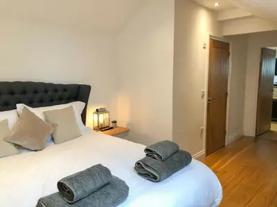 a bedroom with a bed with towels on it at The Hideaway in St Ives
