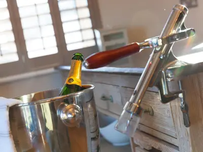 a bottle of champagne in a bucket in a kitchen at 7 Four Seasons in St Ives