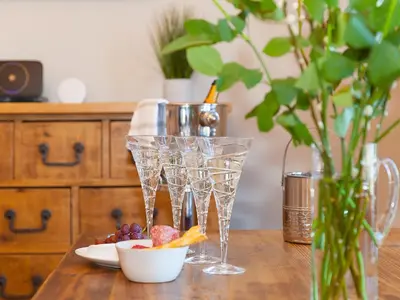 a wooden table with glasses and a bowl of fruit at 7 Four Seasons in St Ives