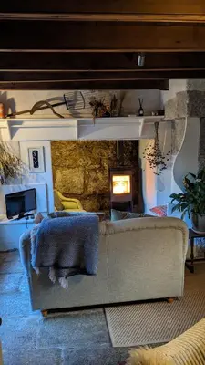 a living room with a couch and a fireplace at The Hideaway in Falmouth