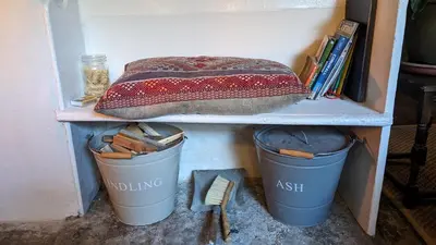 a shelf with two trash cans and a blanket on it at The Hideaway in Falmouth