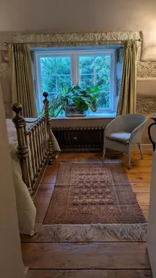 a living room with a staircase and a window at The Hideaway in Falmouth