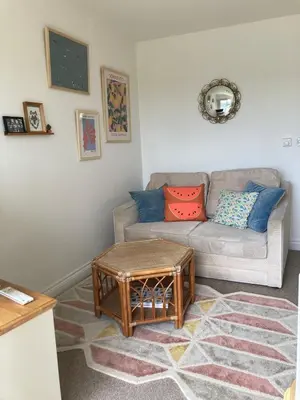 a living room with a couch and a table at Ocean Breeze No 5, Seaview & Parking in Falmouth