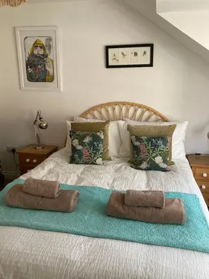 a bedroom with a bed with two towels on it at Ocean Breeze No 5, Seaview & Parking in Falmouth