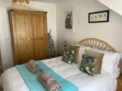 a bedroom with a bed with towels on it at Ocean Breeze No 5, Seaview & Parking in Falmouth