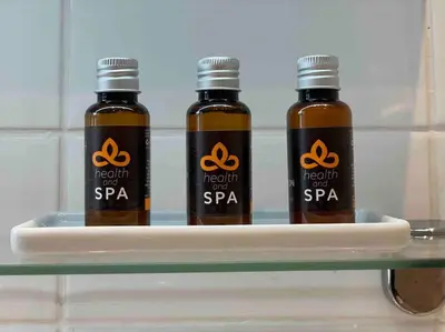three bottles of peanut sauce sitting on a shelf at Luxury Georgian Townhouse Moments from the Harbour in Looe