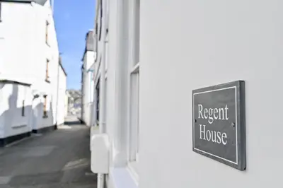 a sign on the side of a building that reads respect the house at Luxury Georgian Townhouse Moments from the Harbour in Looe