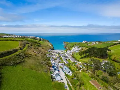 an aerial view of a village on a hill next to the ocean at Stable Cottage in Port Isaac