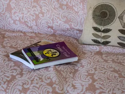 a book sitting on top of a bed at Atlantic Lodge in Port Isaac