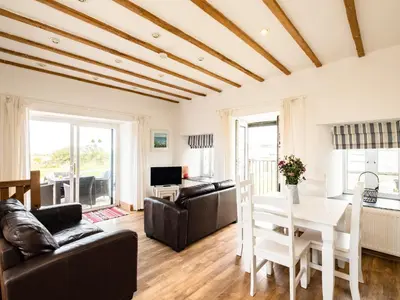 a living room with a couch and a table at Swallow Cottage, Trewetha Farm in Port Isaac