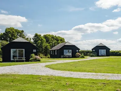 two black cottages on a grass field at Swallow Cottage, Trewetha Farm in Port Isaac