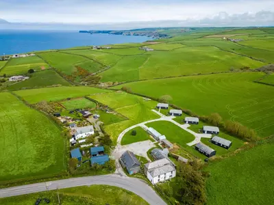 an aerial view of a farm near the ocean at Campion Lodge in Port Isaac