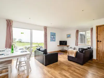 a living room with a table and chairs at Puffin Lodge in Port Isaac