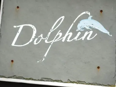 a sign with a dolphin written on it at Dolphin Lodge in Port Isaac