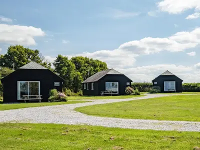 two black cottages on a grass field at Dolphin Lodge in Port Isaac